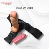 Strap on dildo with pink keychain on a white background, featuring 'it's pleazure' branding.