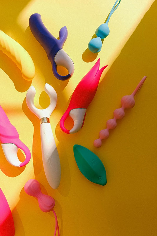 Sex toys huddled in a yellow floor and are glowing in the sunlight