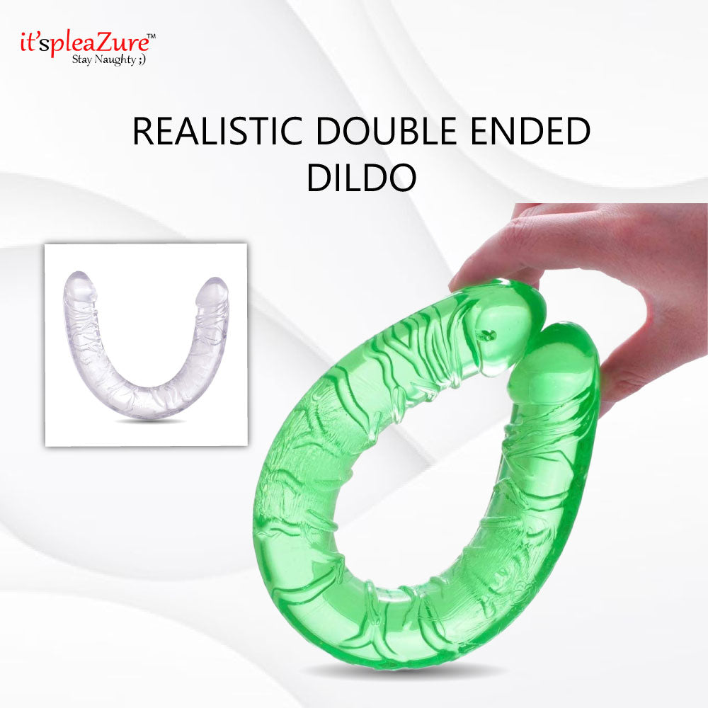 Green double-ended dildo held by a hand with 'it's pleaZure' branding.