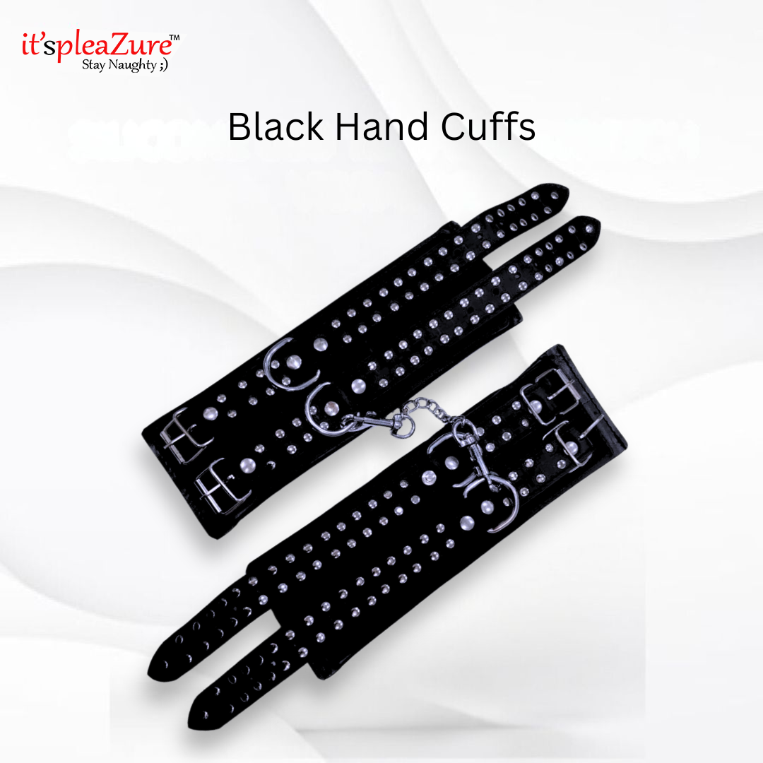 Black hand cuffs with studded details on a white background, featuring the brand 'it's pleazure'.